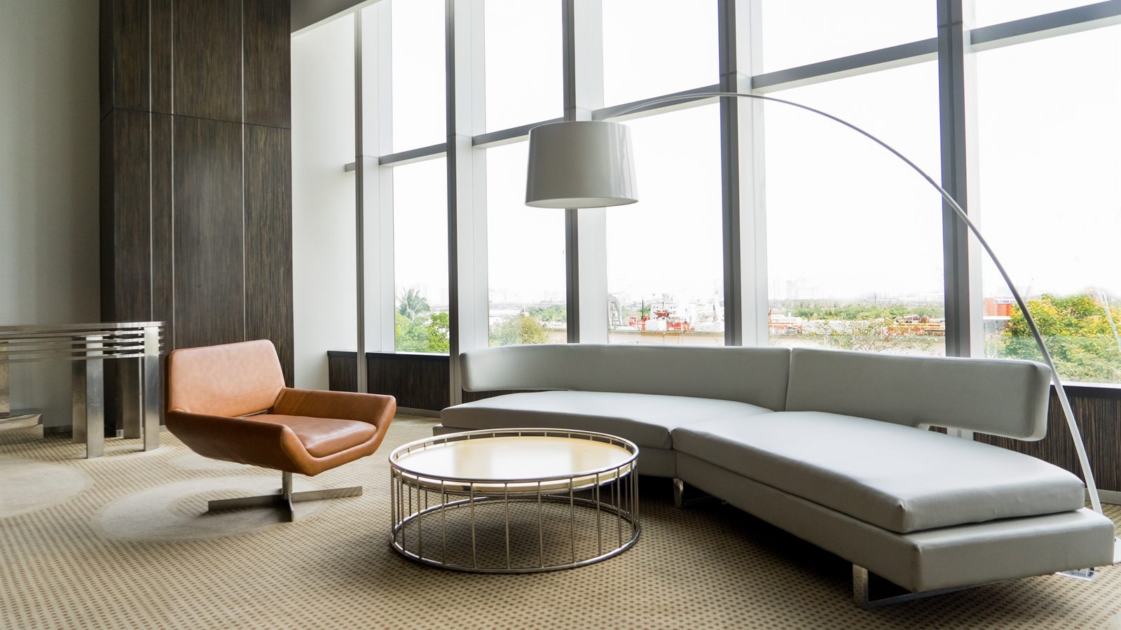 A lounge with floor to ceiling windows. An info point on the window has opened a note.